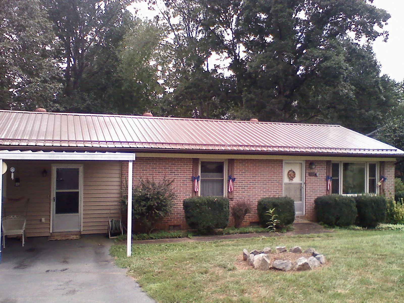 Bronze metal roof and carport on a brick ranch home — Roof Repair work by our crew in Monteview